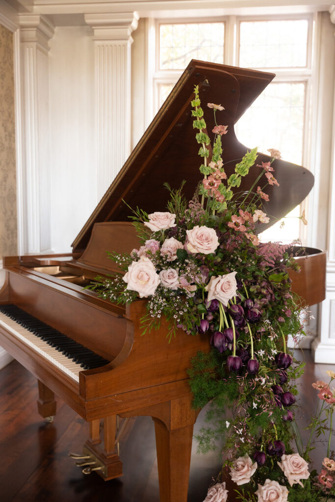 piano adorned with flower installation in european inspired wedding editorial