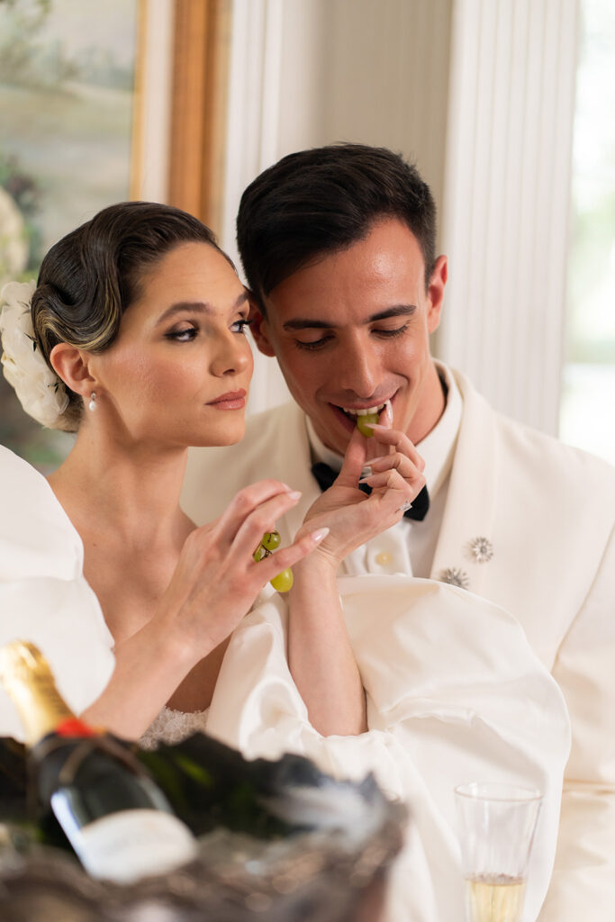 bride feeing groom a grape