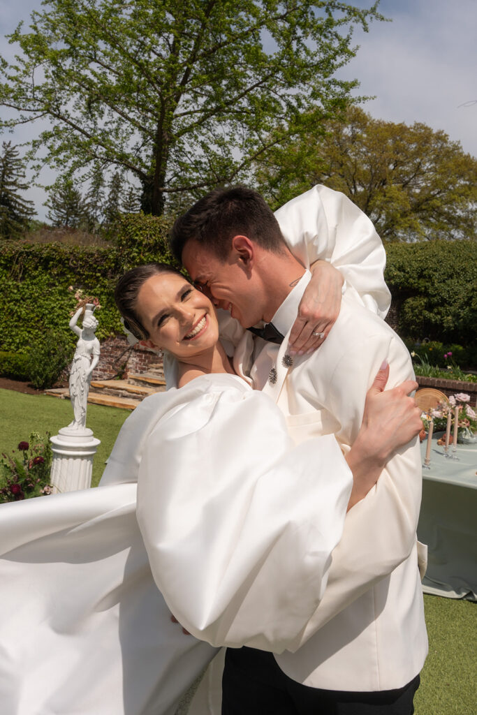 bride and groom embracing in the garden shot by editorial wedding duo young plant weddings