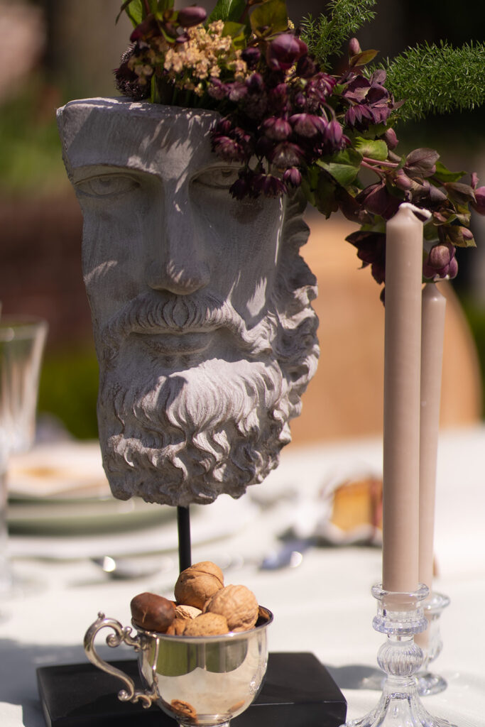 statue adorned with flowers in european inspired wedding editorial