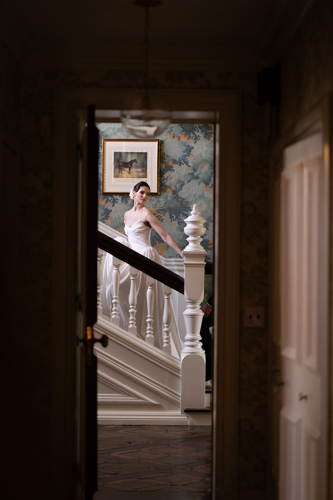 bride looking back over her shoulder while walking up the stairs