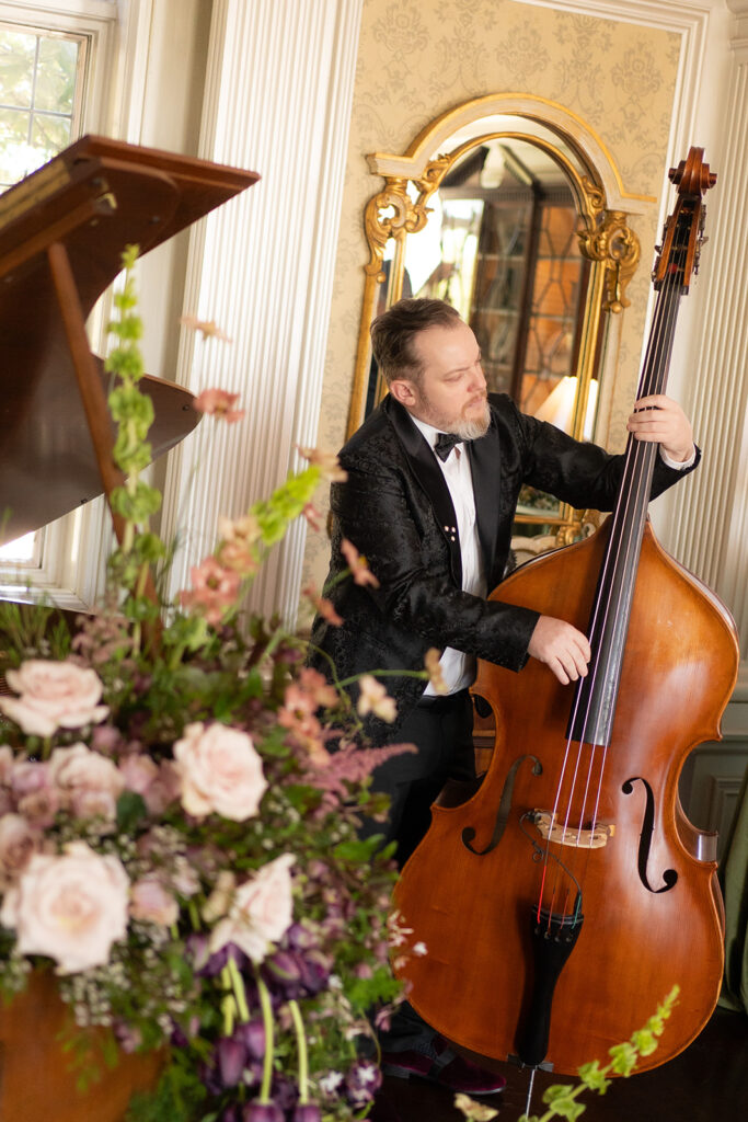 musician playing bass with flowers in european inspired wedding editorial